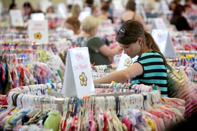 A smart mom shopping for childrens clothes at our consignment sale
